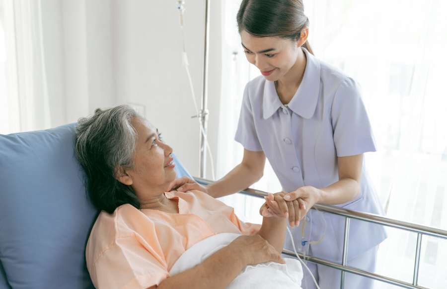 Hospice nurse coordinating care with assisted living and skilled nursing facility staff to provide comfort-focused hospice care where a resident lives